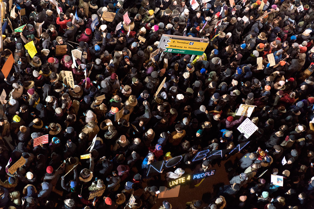 Protesters assemble at John F. Kennedy International Airport in New York, Saturday, Jan. 28, 2017, after earlier in the day two Iraqi refugees were detained while trying to enter the country. (AP/Craig Ruttle)