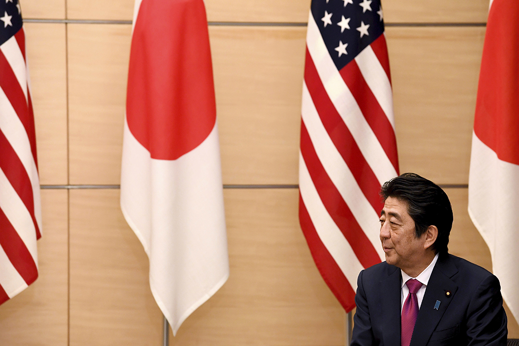 Japanese Prime Minister Shinzo Abe speaks during a joint announcement of the return of American military land on the island of Okinawa at the Abe's official resident in Tokyo Wednesday, Dec. 21, 2016.   The U.S. and Japan announced this month that Washington will give back to the Japanese government nearly 10,000 acres of land on Okinawa that U.S. Marines use for jungle warfare training (Toshifumi Kitamura/Pool Photo via AP)