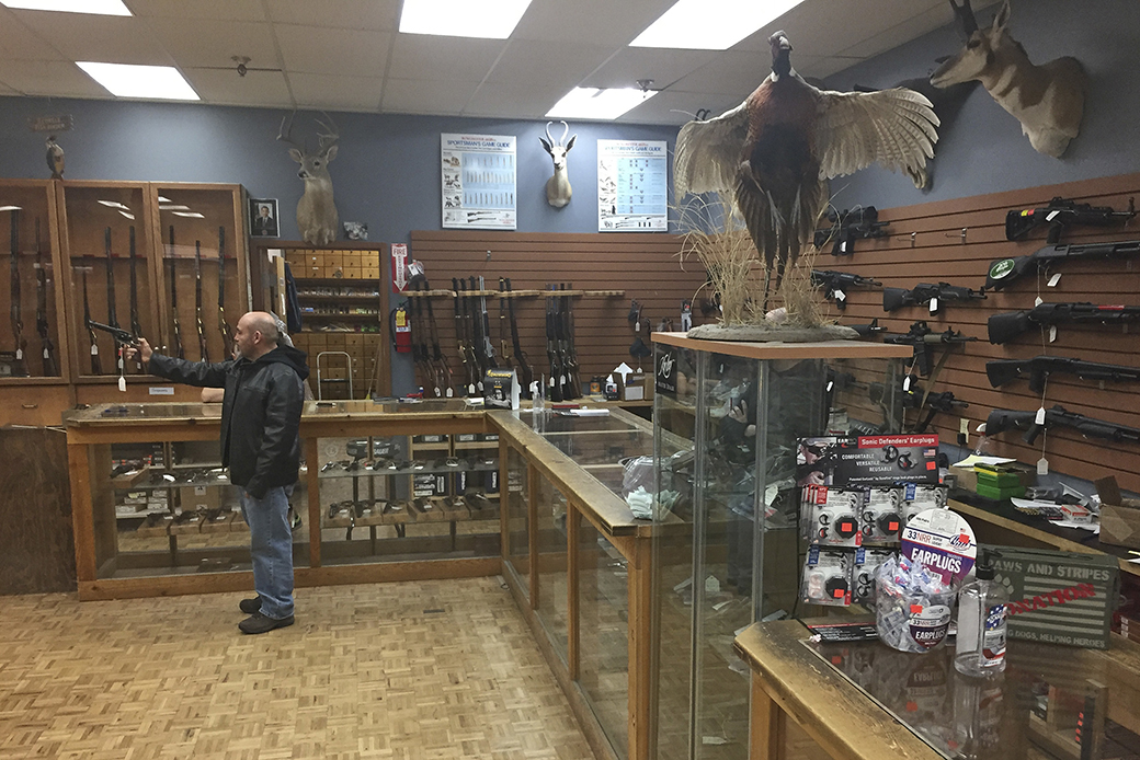A man handles an unloaded firearm at a gun shop in Santa Fe, New Mexico, January 5, 2017. ((AP/Morgan Lee))
