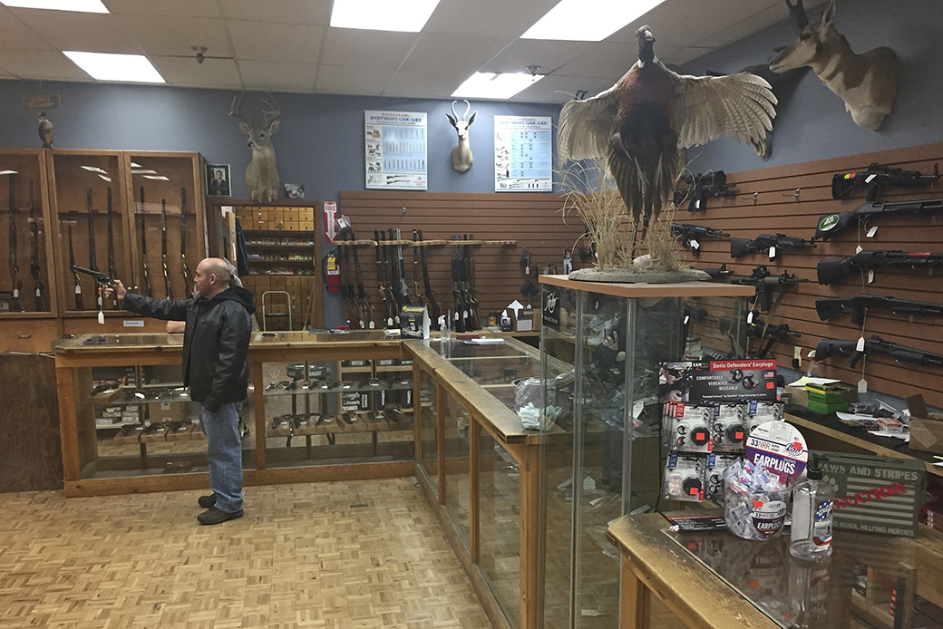 A man handles an unloaded firearm at a gun shop in Santa Fe, New Mexico, January 5, 2017. ((AP/Morgan Lee))