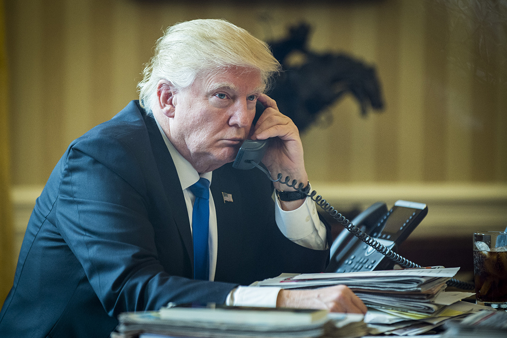 President Donald Trump speaks with Russian President Vladimir Putin on the telephone in the Oval Office, January 28, 2017, in Washington. ((Pete Marovich/Pool via CNP/MediaPunch/IPX))
