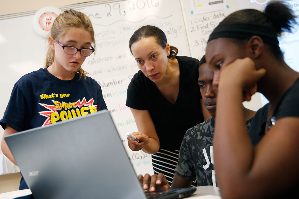 A teacher interacts with students at a school in Las Vegas, Nevada, on June 29, 2016. (AP/John Locher)