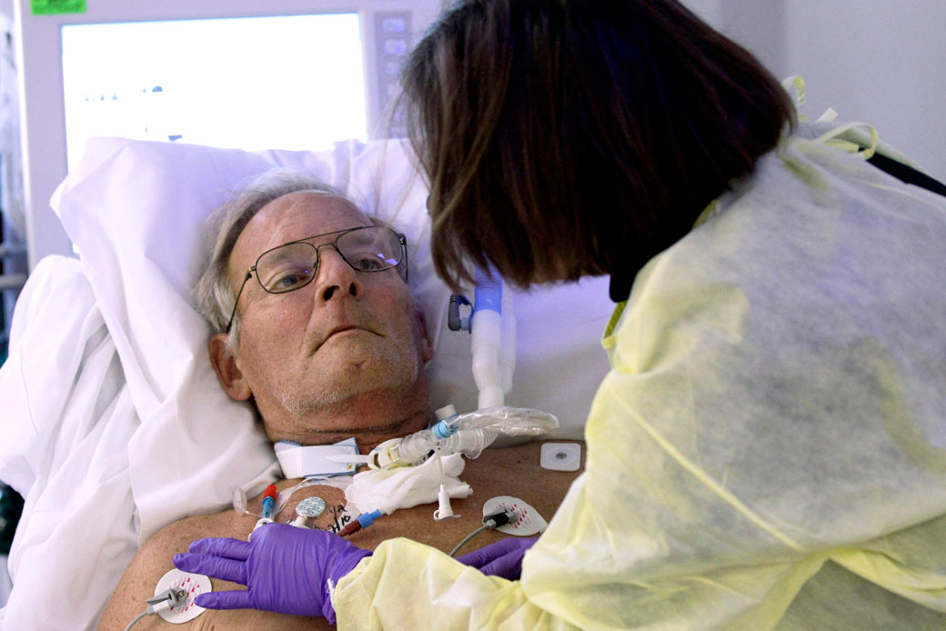 A University of Maryland Medical Center infection control specialist inspects the catheter on a shock trauma center patient on November 17, 2010, in Baltimore. (AP/Rob Carr)