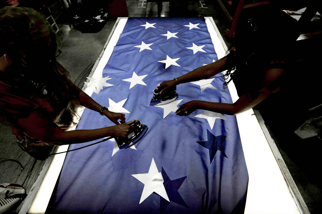 Employees iron stars onto a U.S. flag at Annin Flagmakers in South Boston, Virginia, on July 6, 2016. (AP/Gerry Broome)