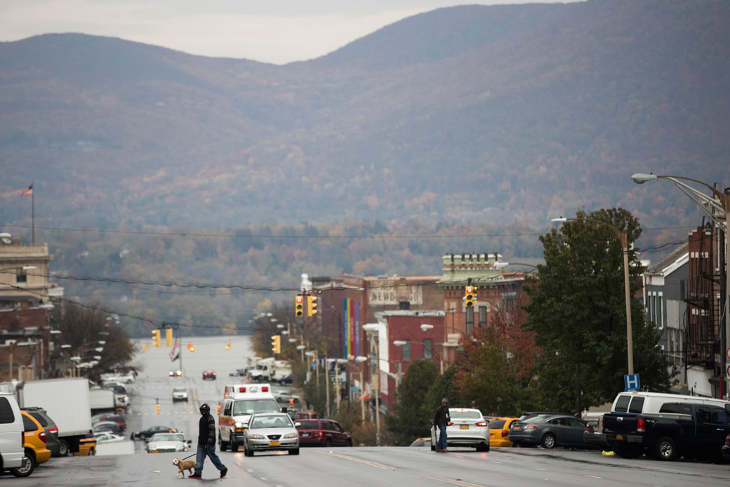 A pedestrian crosses the main street of a New York town on November 3, 2016. (AP/Mike Groll)