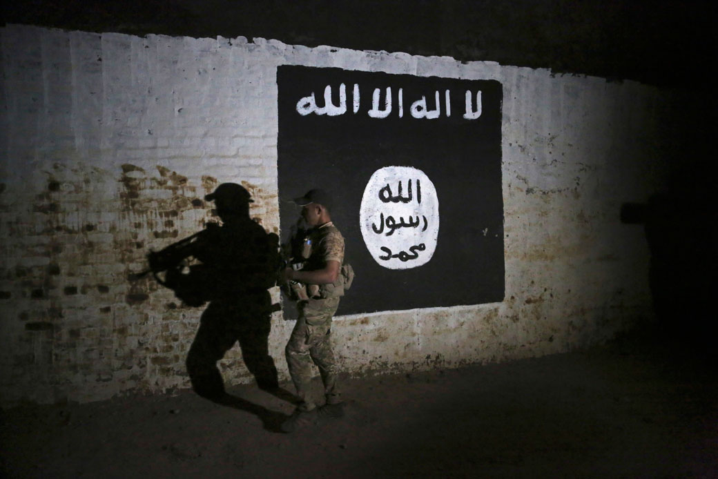 An Iraqi soldier inspects a painting of an Islamic State flag in Mosul, Iraq, on March 1, 2017. (AP/Khalid Mohammed)