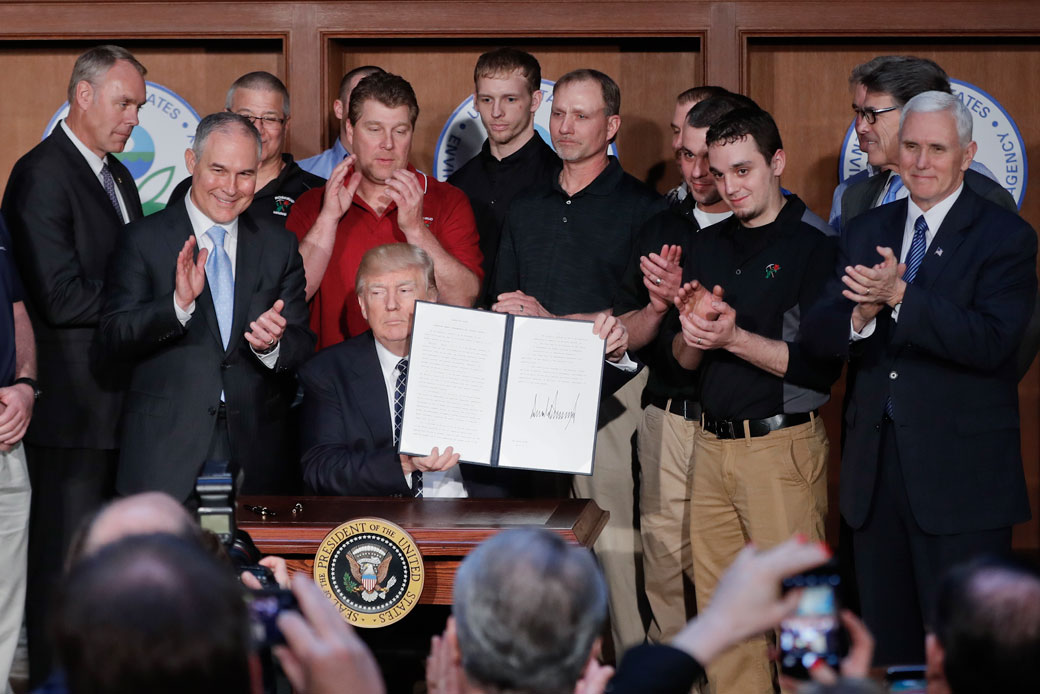 President Donald Trump  holds up the signed Energy Independence Executive Order, March 2017. (AP/Pablo Martinez Monsivais)