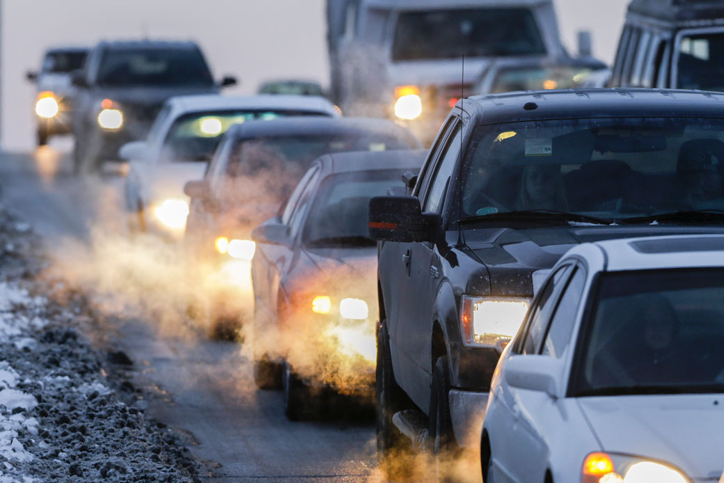 Car exhaust wafts around commuter traffic in Omaha, Nebraska, in February 2013. (AP/Nati Harnik)