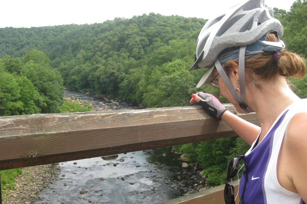 A bicyclist takes in the river view approaching Ohiopyle, Pennsylvania, on July 13, 2012. (AP/Cal Woodward)