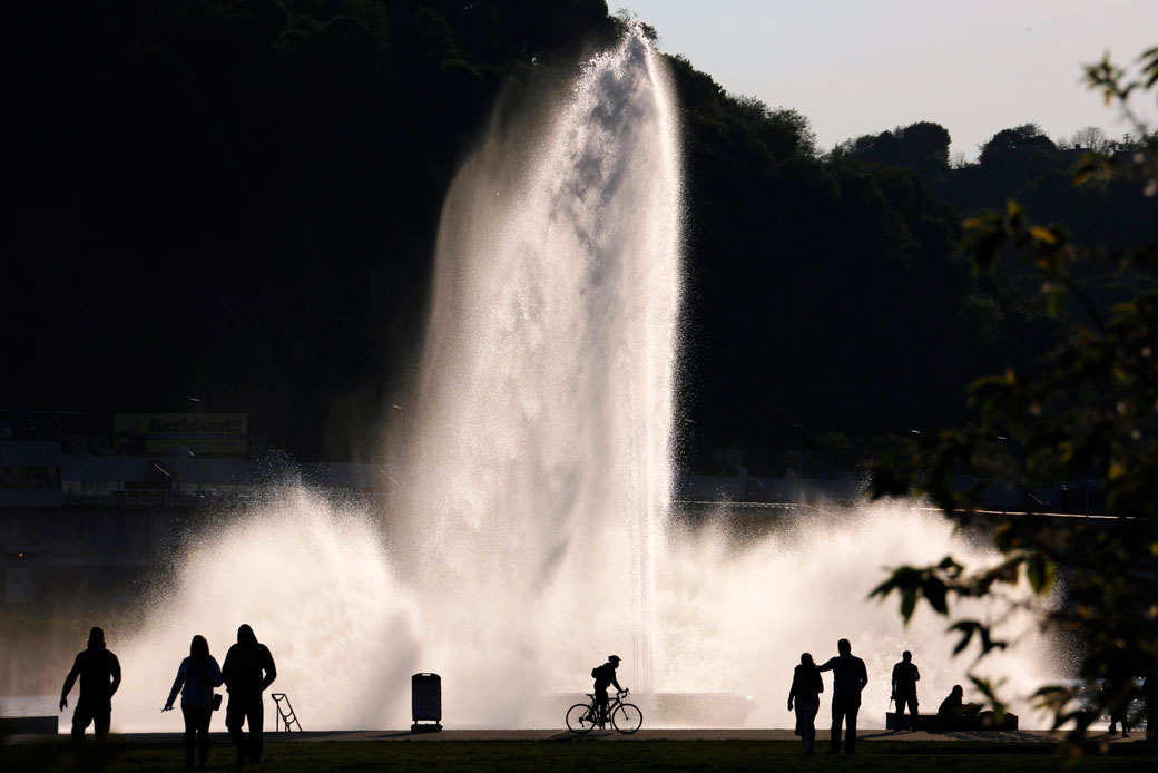 Visitors to Point State Park are silhouetted against a fountain in downtown Pittsburgh on May 8, 2016. (AP/Gene J. Puskar)