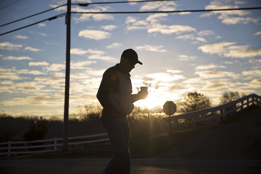 A man walks with a cup of coffee after dropping his car off for repair as the sun rises in Lula, Georgia, January 12, 2017. ((AP/David Goldman))