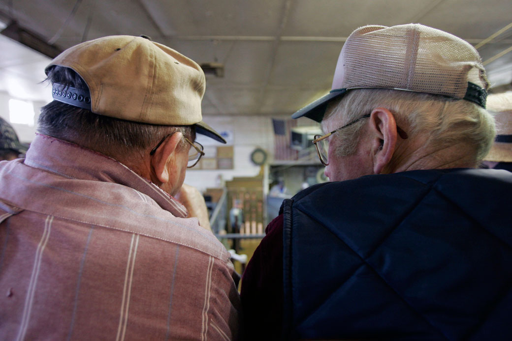 Two men talk during the livestock auction at Belleville Farmers Market & Livestock in Belleville, Pennsylvania. (AP/Carolyn Kaster)