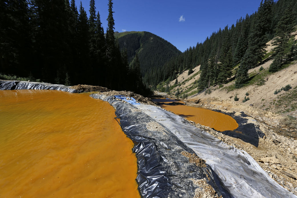 Water flows through sediment retention ponds built to reduce heavy metal and chemical contaminants from the Gold King Mine wastewater accident outside Silverton, Colorado, on August 14, 2015. (AP/Brennan Linsley)