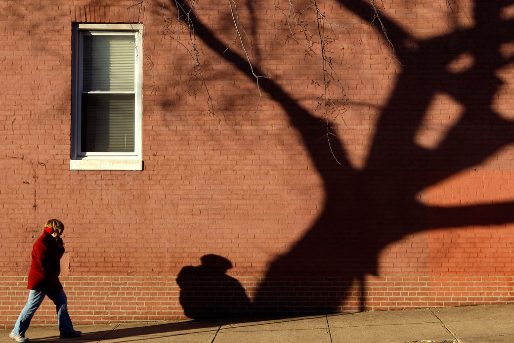 A woman walks on a street in Baltimore, February 6, 2012. (AP/Patrick Semansky)