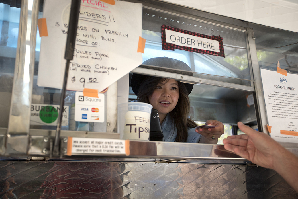 A food truck co-owner hands a credit card back to a customer after taking an order in Burbank, California, July 2015. (AP/Jae C. Hong)