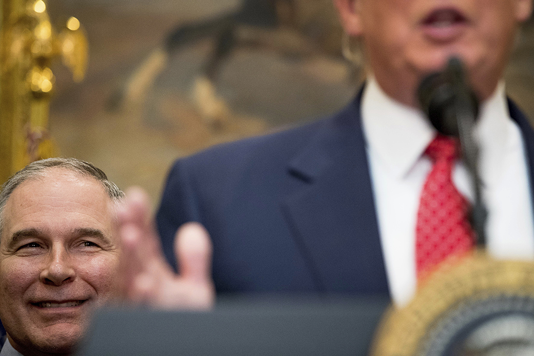 Environmental Protection Agency Administrator Scott Pruitt listens at left as President Donald Trump speaks before signing the Waters of the United States executive order, February 28, 2017, in the Roosevelt Room in the White House in Washington. ((AP/Andrew Harnik))