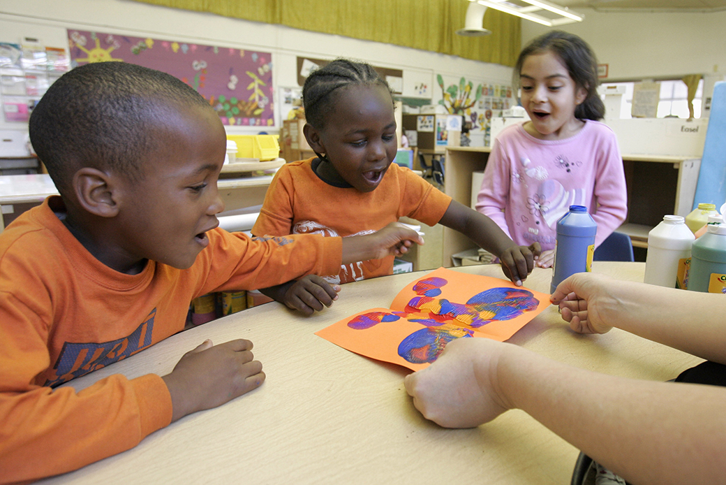 Preschoolers Raymond Gilliam, left, Devon Edwards, center, and Hilda Torres look at the butterfly Edwards made for a Mother's Day card at a publicly funded preschool class in Sacramento, California, May 2006. (AP/Rich Pedroncelli)