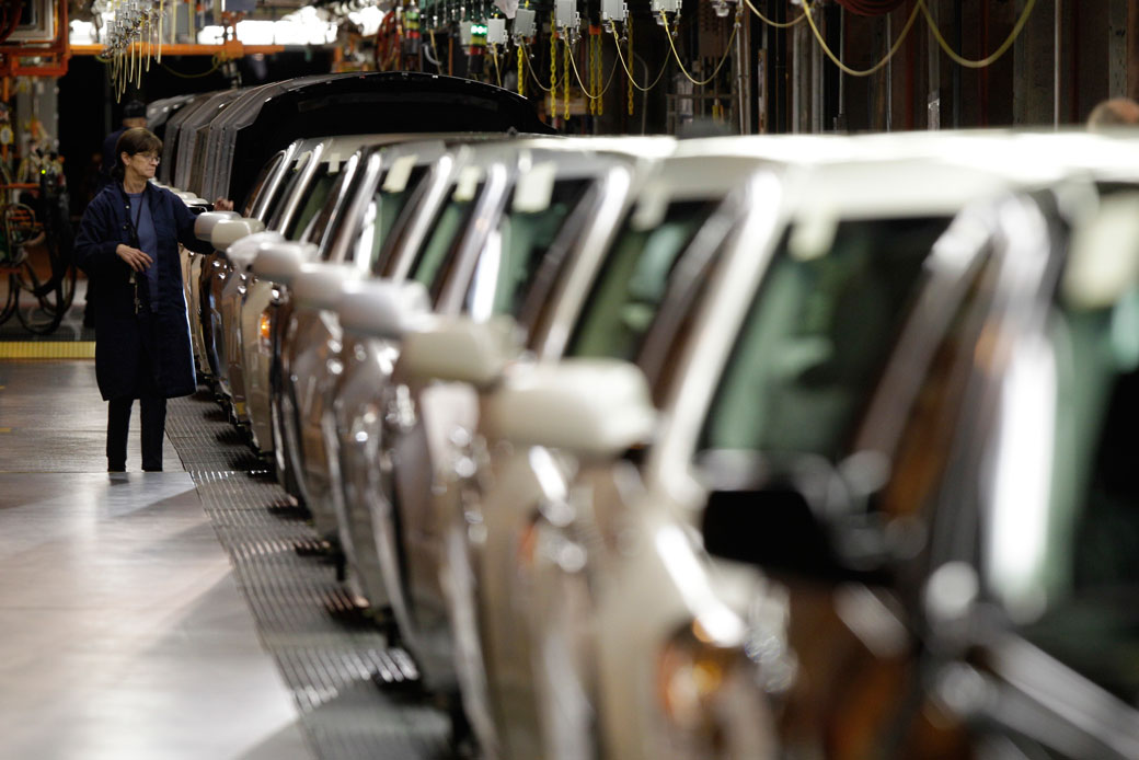 A line worker checks vehicles at the General Motors Hamtramck assembly plant in Hamtramck, Michigan, November 30, 2010. (AP/Paul Sancya)