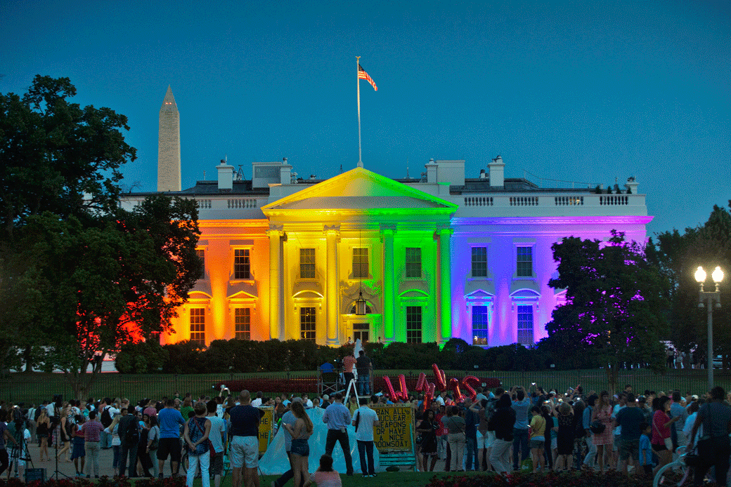 People gather in Lafayette Park to see the White House illuminated with rainbow colors in commemoration of the U.S. Supreme Court's ruling to legalize same-sex marriage in Washington on June 26, 2015. (AP/Pablo Martinez Monsivais)