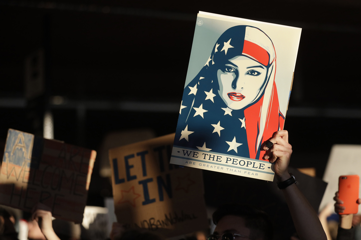 A protester holds a sign at San Francisco International Airport during a demonstration to denounce President Donald Trump's immigration executive order, January 2017. (AP/Marcio Jose Sanchez)