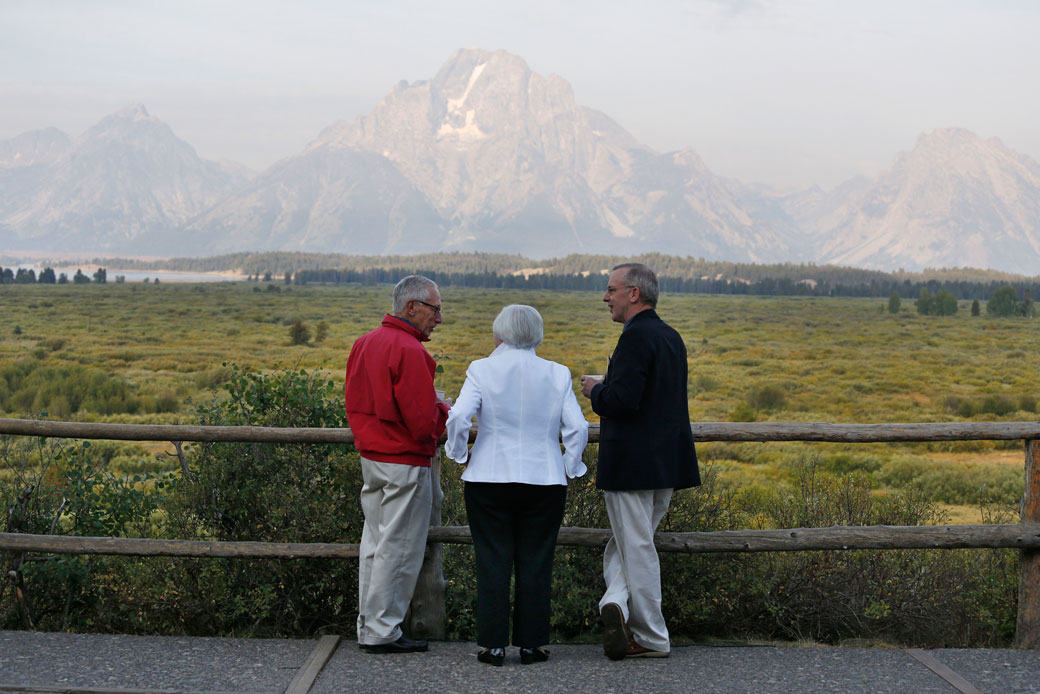 Federal Reserve Chair Janet Yellen, center; Fed Board of Governors Vice Chair Stanley Fischer, left; and Federal Reserve Bank of New York President Bill Dudley view Grand Teton Mountain during a conference on August 26, 2016, in Jackson Hole, Wyoming. (AP/Brennan Linsley)