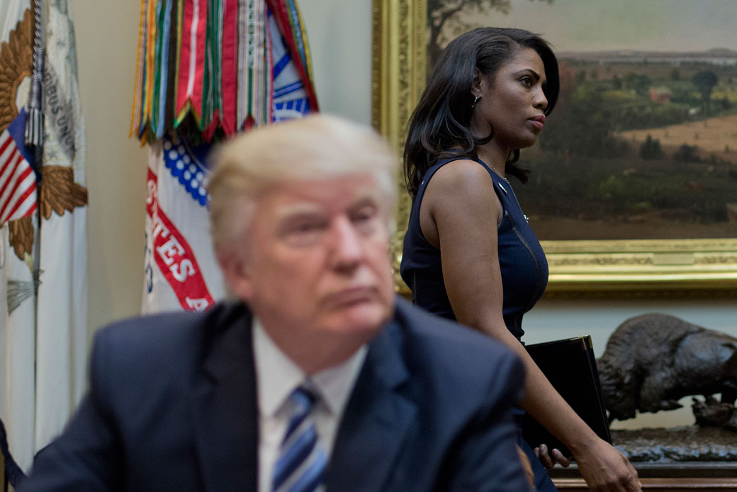White House Director of Communications for the Office of Public Liaison Omarosa Manigault, right, walks past President Donald Trump in the Roosevelt Room of the White House, March 2017. (AP/Pablo Martinez Monsivais)