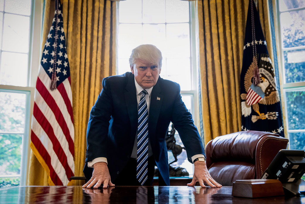 President Donald Trump poses for a portrait in the Oval Office in Washington, April 2017 (AP/Andrew Harnik)