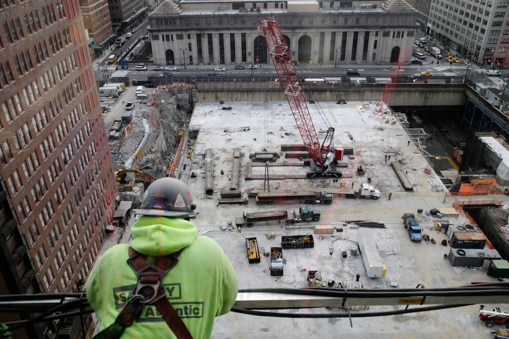 A worker looks down on the site of a construction project in New York City on January 21, 2015. (AP/Mark Lennihan)