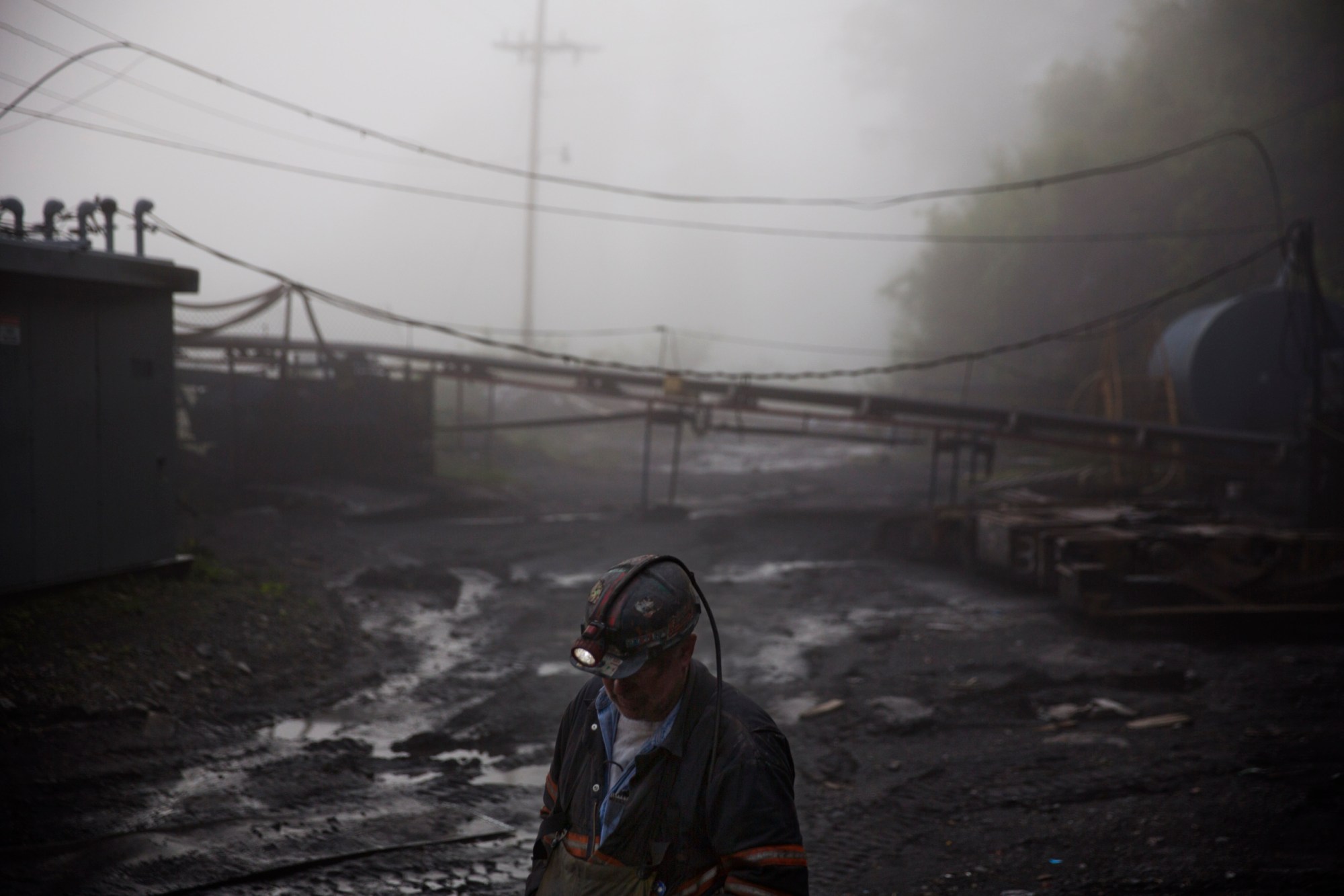 CLIMATE CHANGE: In this Thursday, May 12, 2016 photo, coal miner Scott Tiller walks through the morning fog before going underground in a mine less than 40-inches high in Welch, W.Va. For over a century, life in Central Appalachia has been largely defined by the ups and downs of the coal industry. There is a growing sense in these mountains that for a variety of reasons, economic, environmental, political, coal mining will not rebound this time. Coal's slump is largely the result of cheap natural gas, which now rivals coal as a fuel for generating electricity. Older coal-fired plants are being idled to meet clean-air standards. According to the Labor Department, there were 56,700 jobs in coal mining in March, down from 84,600 in March 2009, shortly after President Barack Obama entered office. There are stark differences between the two parties on energy and environment issues that underscore the sky-high stakes for both sides of the debate in the 2016 presidential race. Many environmental groups and Democrats fear a potential rollback of the Obama administrations policies on climate change and renewable energy under a Republican president. Republicans all support coal production and enthusiastically back nuclear energy. They along with business groups are eager to boost oil and gas production following years of frustration with Obama. (AP Photo/David Goldman)