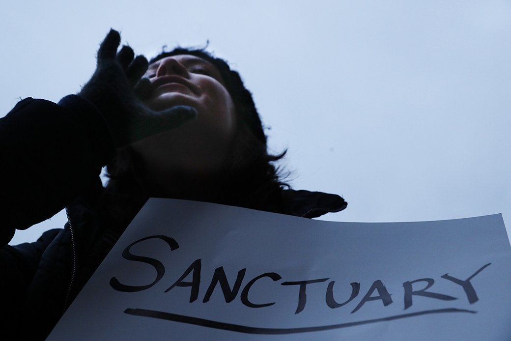 Demonstrators chant against an executive order from President Donald Trump on immigration, January 30, 2017, outside City Hall in Cincinnati. (AP/John Minchillo)