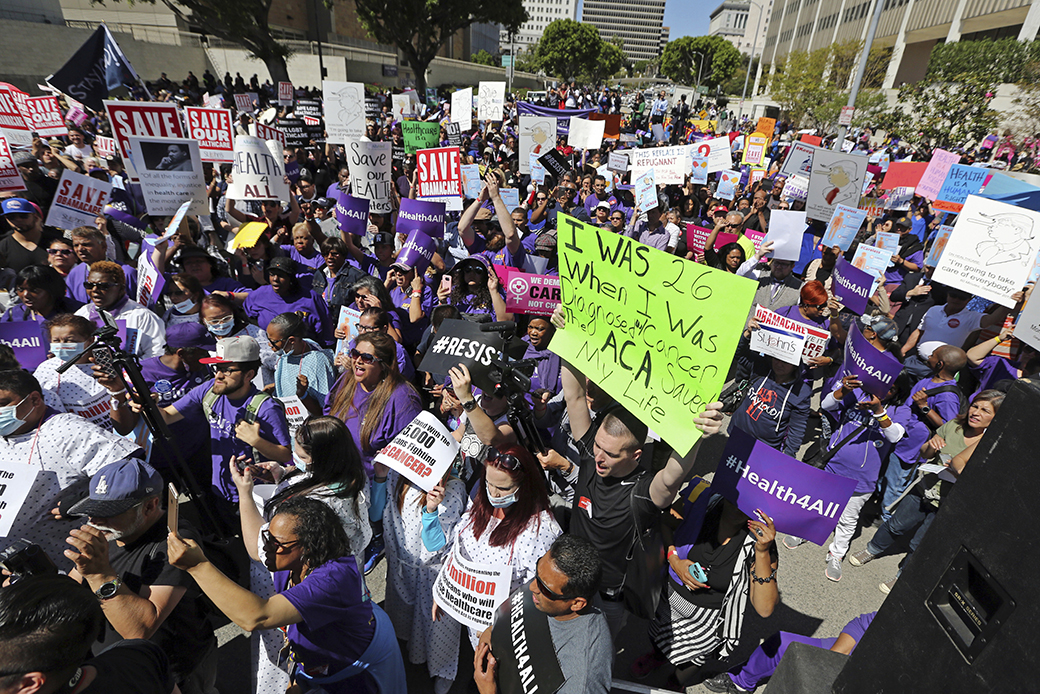 Hundreds of people march through downtown Los Angeles protesting President Donald Trump's plan to dismantle the Affordable Care Act, March 23, 2017. (AP/Reed Saxon)