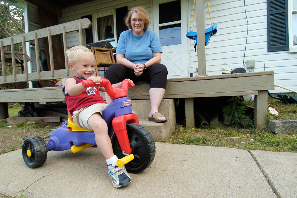 Three-year-old Cody Snyder, who has cerebral palsy, plays in his front yard in Bloomingdale, Ohio, with his mother Dawn on June 5, 2007. (AP/Mark Stahl)