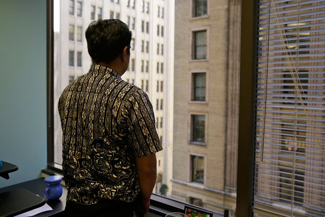 An Indonesian fisherman who escaped slavery looks out the window at the San Francisco offices of the Legal Aid Society on September 22, 2016. (AP/Eric Risberg)