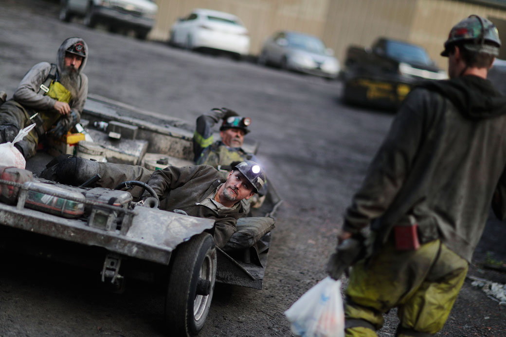 In this May 12, 2016, photo, coal miner Scottie Stinson, front, drives a man trip as he and fellow workers head into an underground mine less than 40-inches high to start their shift in Welch, West Virginia. (AP/David Goldman)