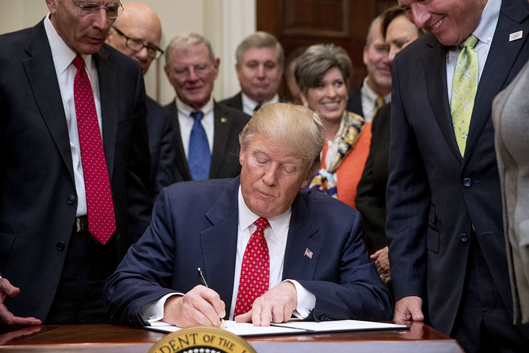 President Donald Trump signs the Waters of the United States executive order, February 28, 2017, in the Roosevelt Room in the White House in Washington. (AP/Andrew Harnik)