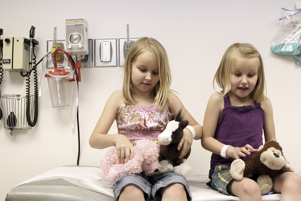 Sisters play with stuffed animals during a check-up with their pediatric cardiologist at a medical center in Dallas, April 2008. (AP/Amy Conn-Gutierrez)