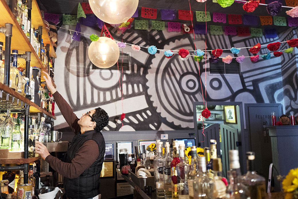 Luis Arce Mota, the chef and co-owner of La Contenta, checks the inventory of his restaurant, February 16, 2017, in New York. (AP/Mark Lennihan)