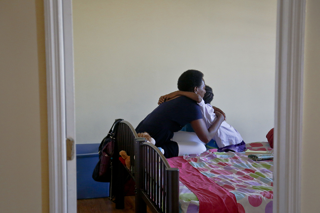 A mother hugs her daughter during a chat, July 2016. (AP/Bebeto Matthews)