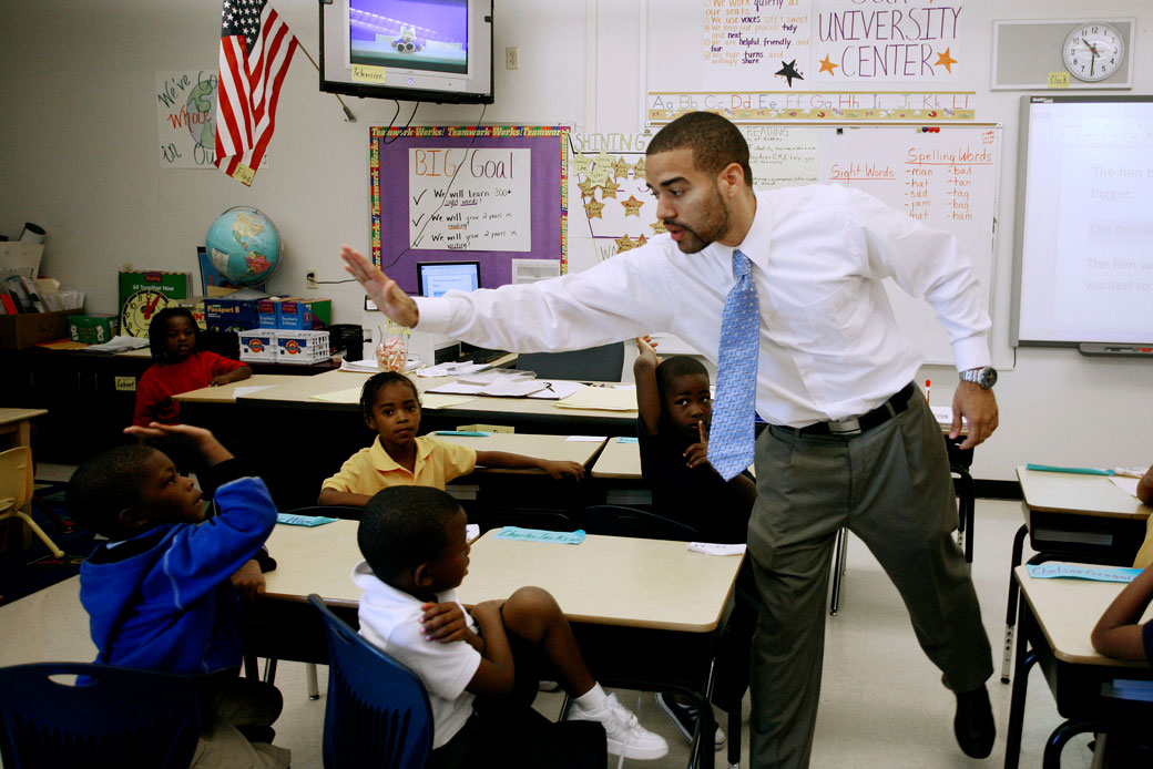 A teacher high fives a student at an elementary school in Miami, September 1, 2011. (AP/J Pat Carter)