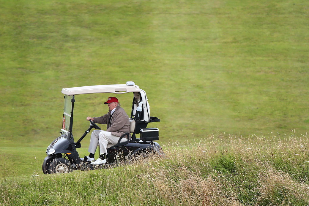 Then-presidential candidate Donald Trump drives his golf buggy on the Turnberry golf course in Scotland, July 31, 2015. (AP/Scott Heppell)