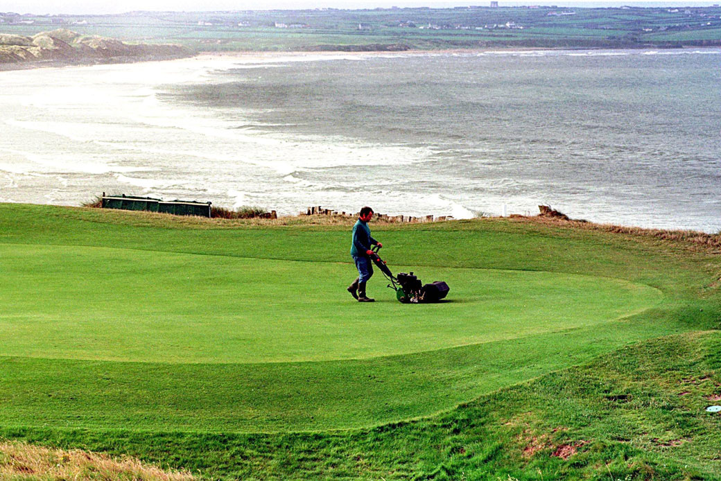 The greens at a golf course in Ireland get their daily manicure, August 1998. (AP/John Cogill)