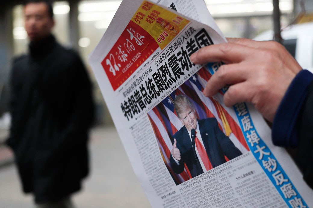A man reads a newspaper in Beijing, November 10, 2016. (AP/Andy Wong)