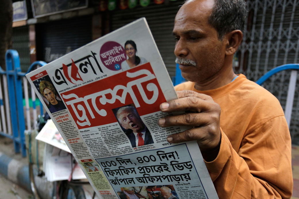 An man reads a Bengali-language newspaper in Kolkata, India, November 10, 2016. (AP/Bikas Das)