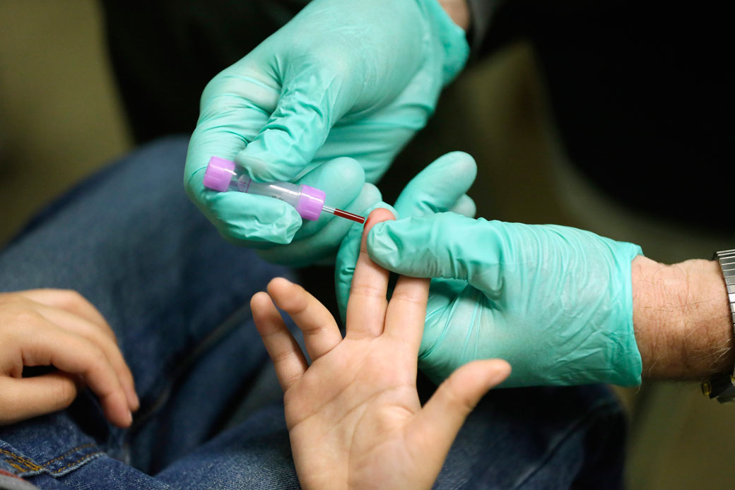 A nurse draws a blood sample from a student at an elementary school in Flint, Michigan, to test for lead after the metal was found in the city's drinking water. (AP/Carlos Osorio)