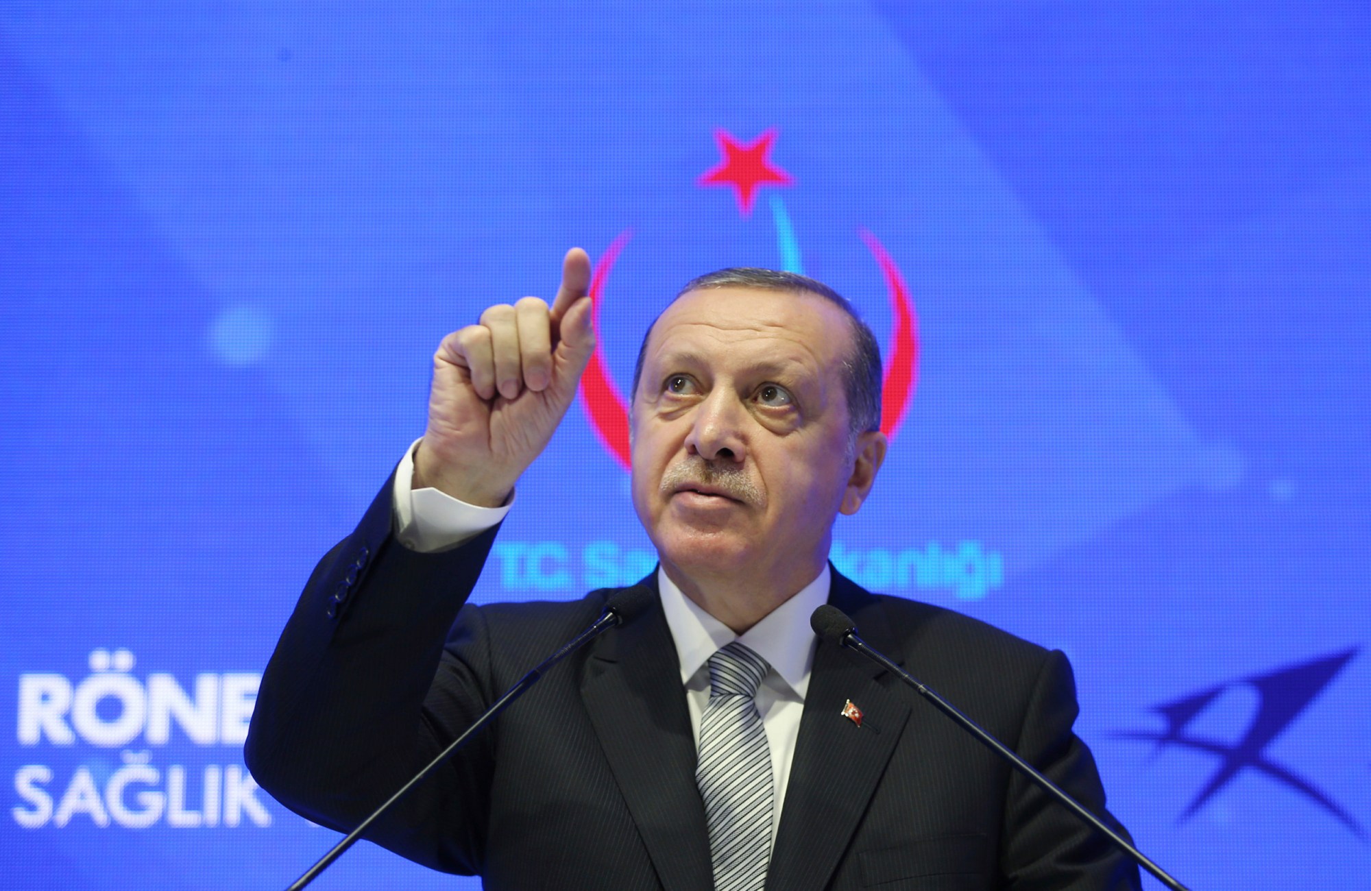 Turkey's President Recep Tayyip Erdogan speaks during a meeting in Istanbul, Friday, July 21, 2017. Erdogan has accused Germany's government of trying to scare off investments to Turkey with lies, after Germany toughened its stance toward Ankara following the arrest of human rights activists, including a German national.(Presidential Press Service/Pool photo via AP)