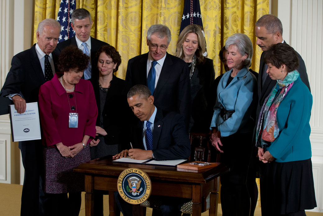 Former President Barack Obama signs a memorandum creating a task force to respond to campus rape during an event for the Council on Women and Girls in Washington, D.C., January 2014. (AP/Carolyn Kaster)