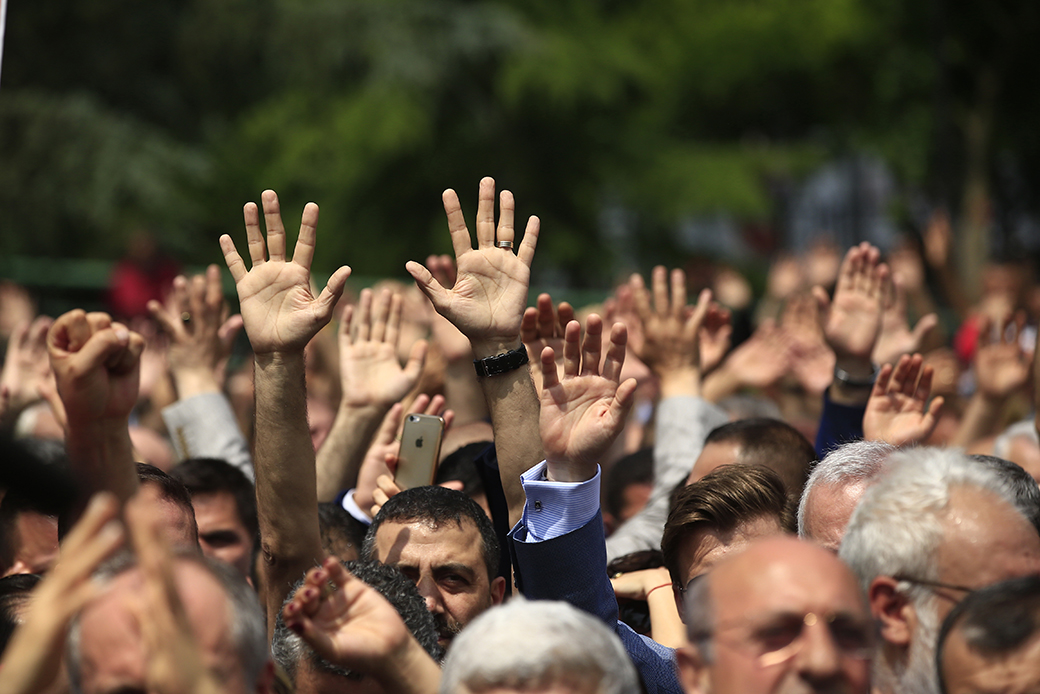 Supporters of Turkey's pro-secular Republican People's Party (CHP) wave their hands and chant slogans as they gather for a protest in Istanbul, June 15, 2017. (AP/Lefteris Pitarakis)
