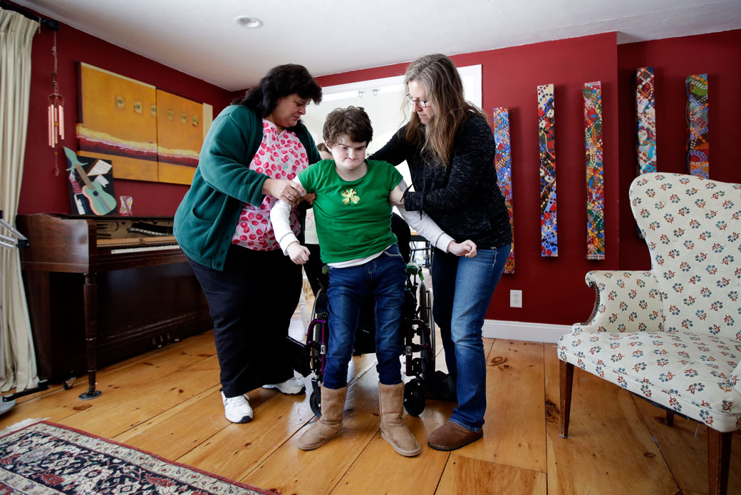 An in-home nurse helps steady her patient in Brentwood, New Hampshire, on March 17, 2017. (AP/Charles Krupa)