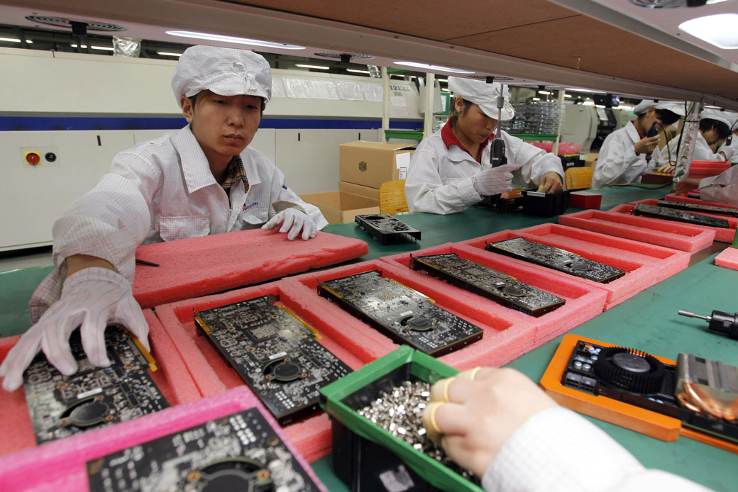 Staff members work on the production line at the Foxconn complex in Shenzhen, China, May 2010. (AP/Kin Cheung)
