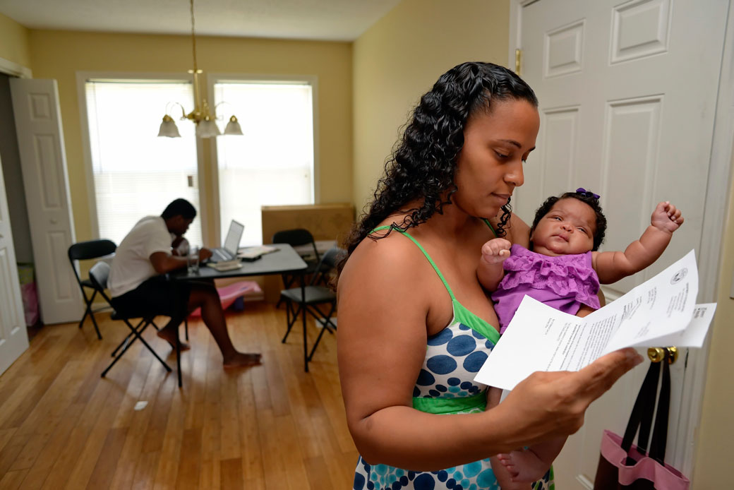 A woman holds her 2-month-old baby in Greenville, South Carolina, June 2014. (AP/Richard Shiro)